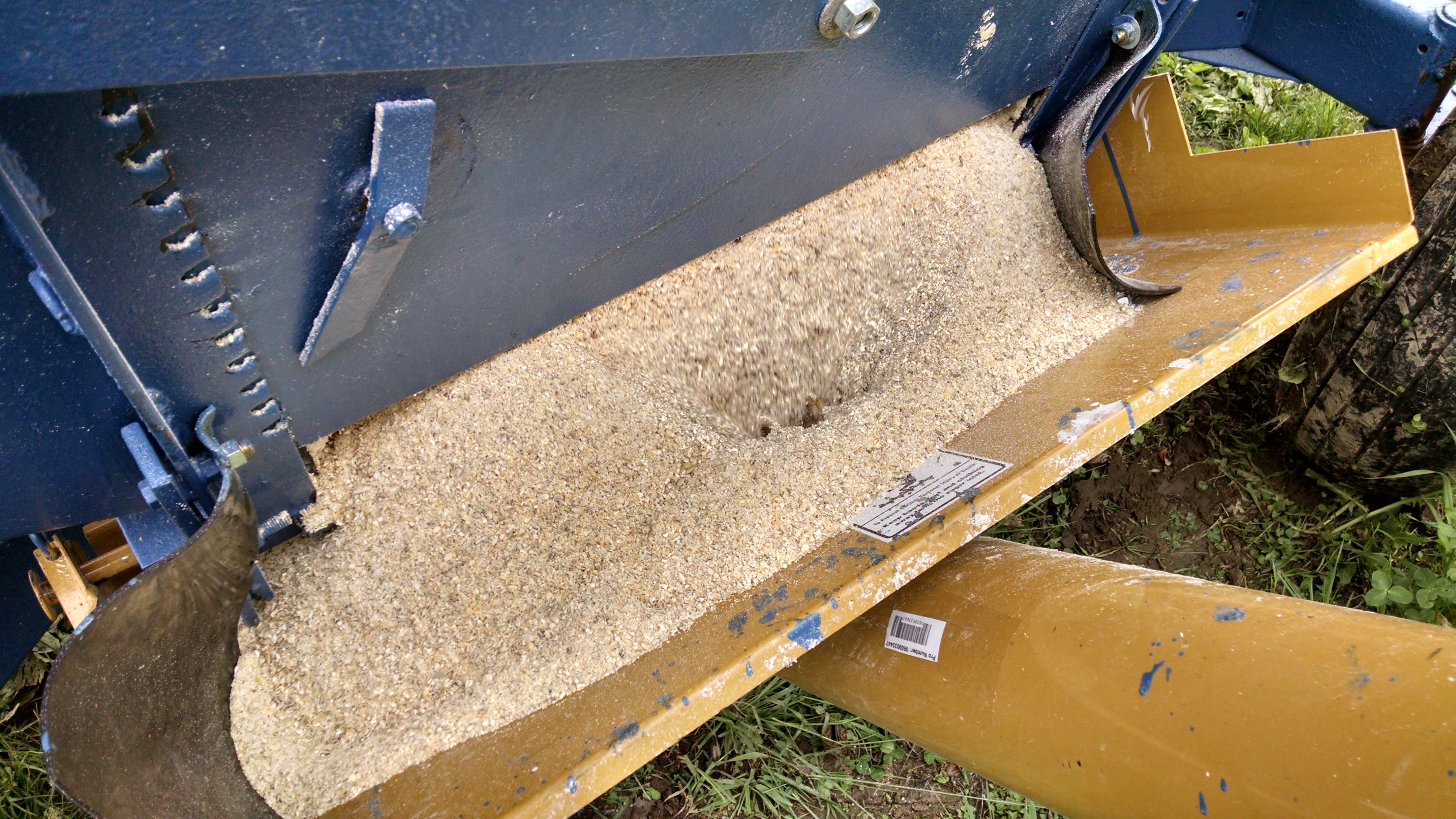 Grain flowing out of the wagon into the auger hopper. I might add a plywood extension to the hopper to prevent overflow problems